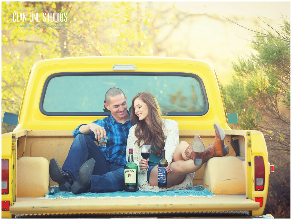 engaged couple smiling on yellow truck