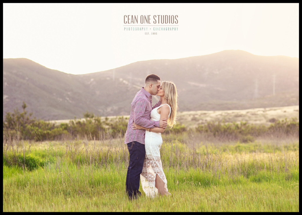 man and woman kissing in front of mountains | San Diego Engagement Photographer
