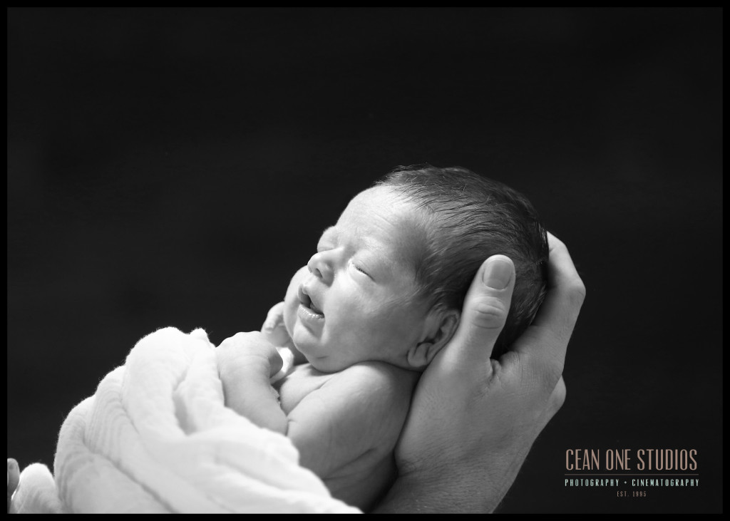 Dad holding newborn | San Diego Photographer
