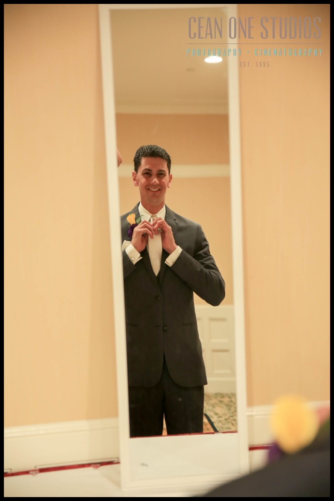Groom getting dressed in mirror | Hotel del Coronado San Diego Wedding Photographer